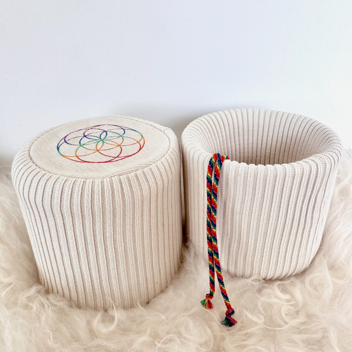 Two Eco-Luxe singing bowl covers in organic cotton showing flower of life base and chakra drawstring