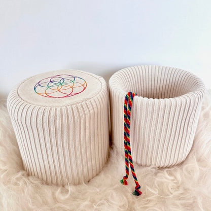 Two Eco-Luxe singing bowl covers in organic cotton showing flower of life base and chakra drawstring